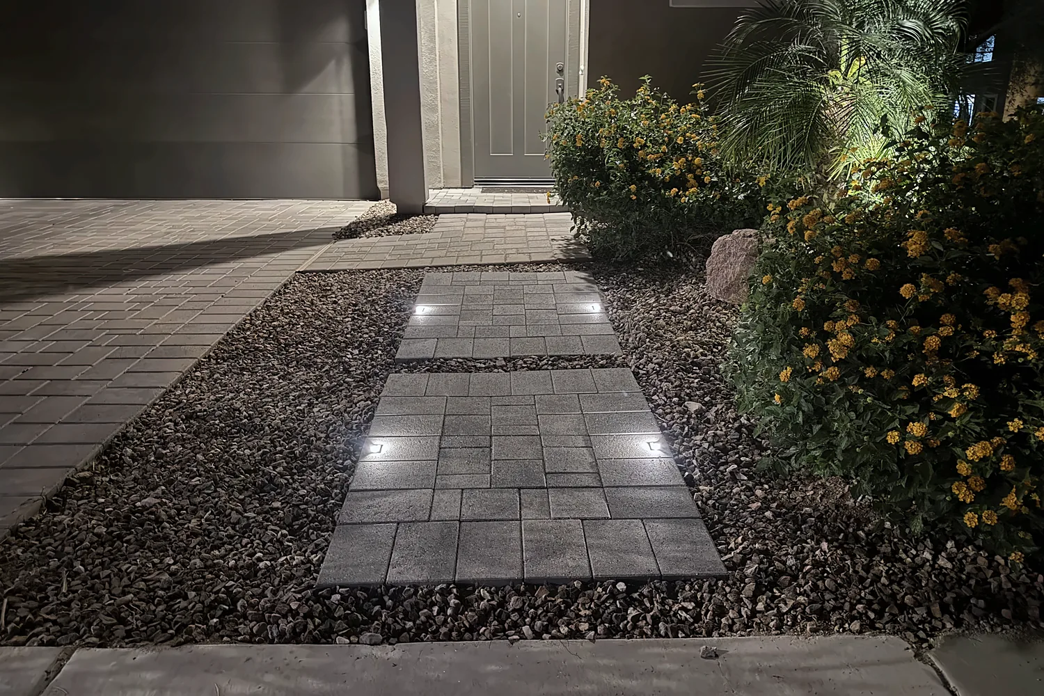 Recessed lights set into a paver walkway